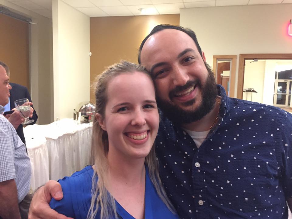 A man and a woman are posing for a picture together
