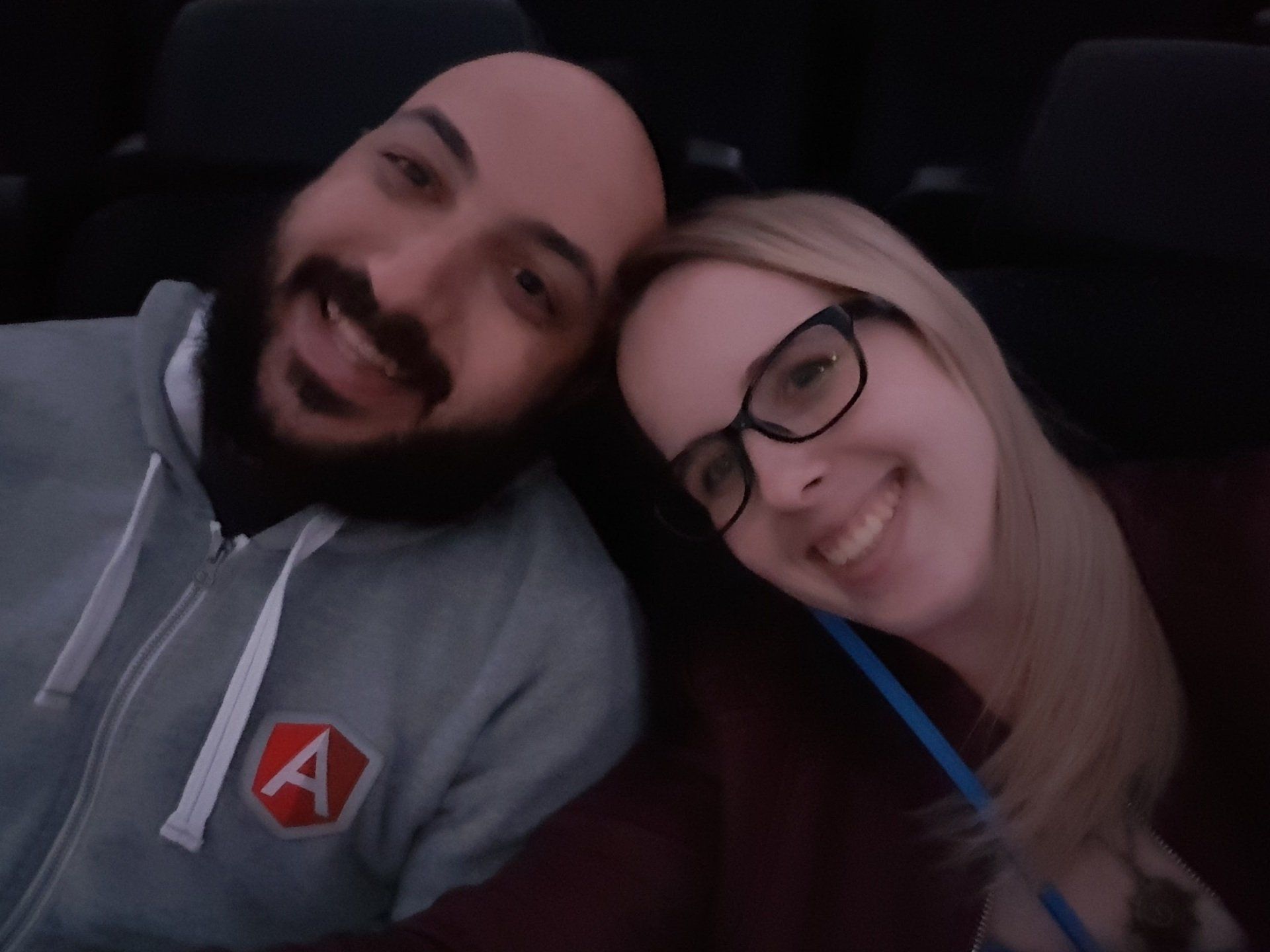 A man wearing a hoodie with the letter a on it