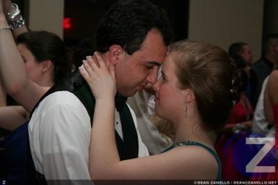 A man and a woman are dancing at a party with the letter z in the corner