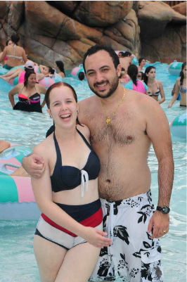 A man and a woman are posing for a picture in the water