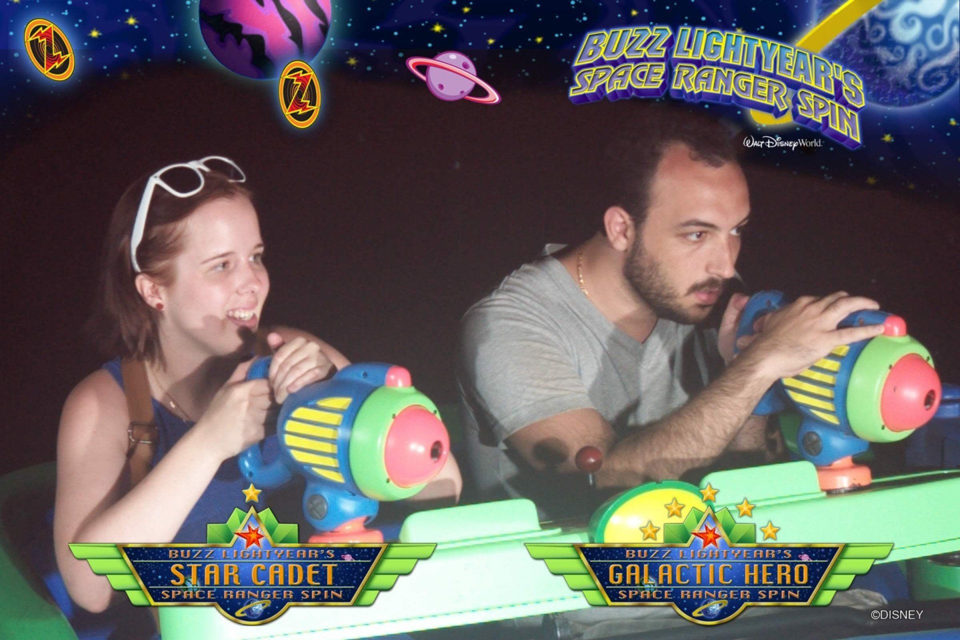 A man and a woman are playing buzz lightyear 's space rangers