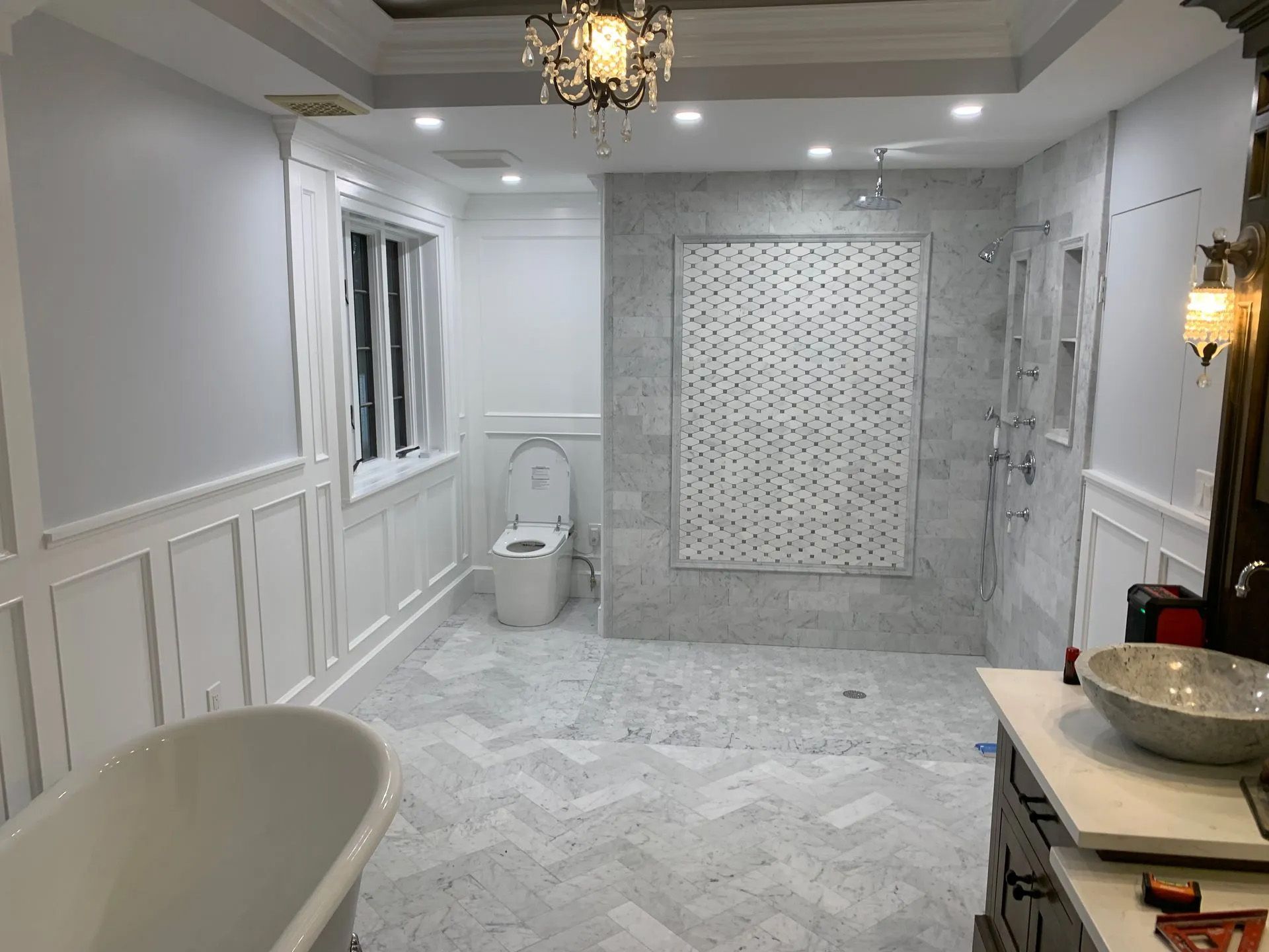 A bathroom with a tub , sink , toilet and shower.