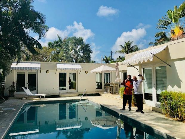 A yellow and blue striped awning on a balcony