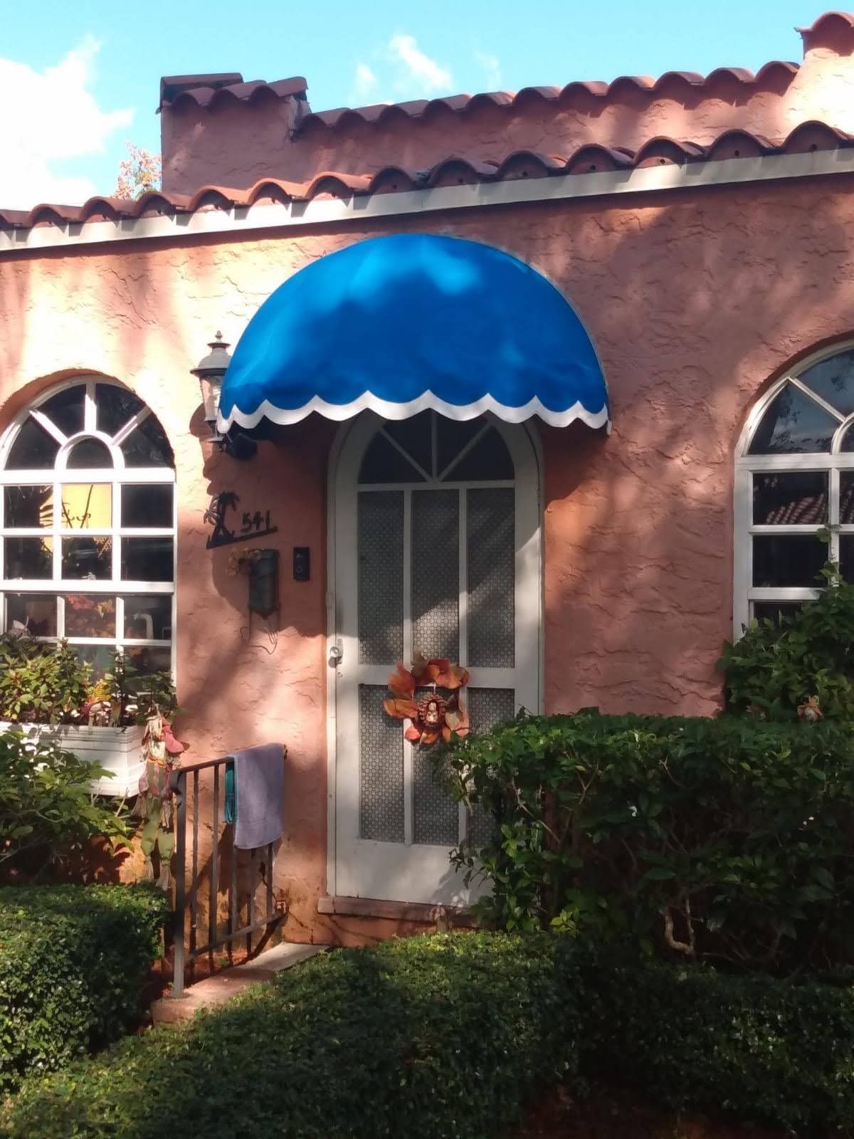 A yellow and blue striped awning on a balcony