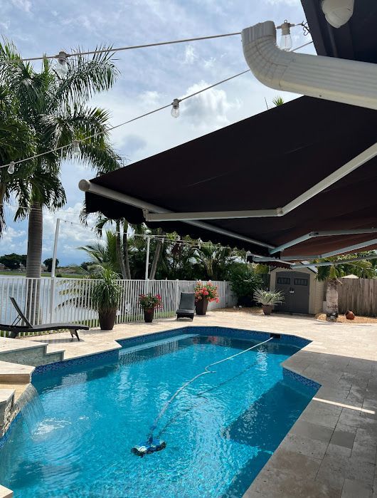A patio with a table and chairs under an umbrella