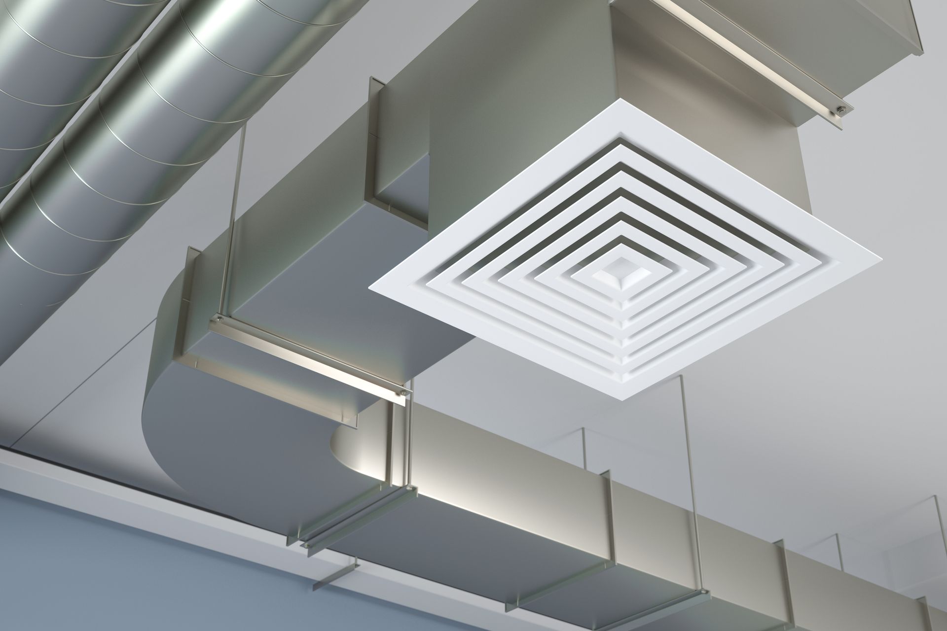 There are a lot of ducts hanging from the ceiling.