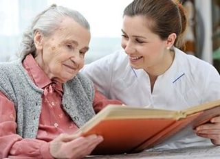 Reading a book with a senior woman - Home Health in Chadds Ford, PA