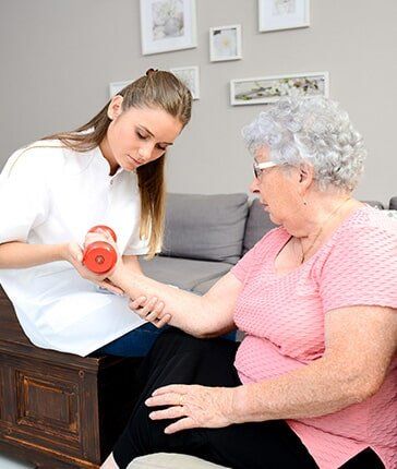Assisting the elderly woman in exercising - Physical Therapy in Chadds Ford, PA Assisting the elderly woman in exercising - Physical Therapy in Chadds Ford, PA