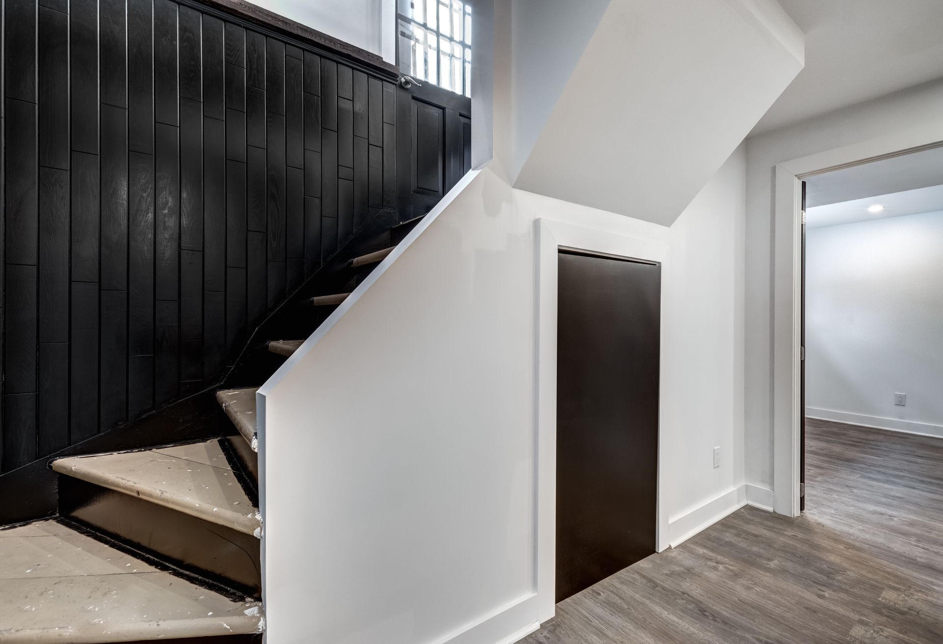 A staircase in a house with a black railing