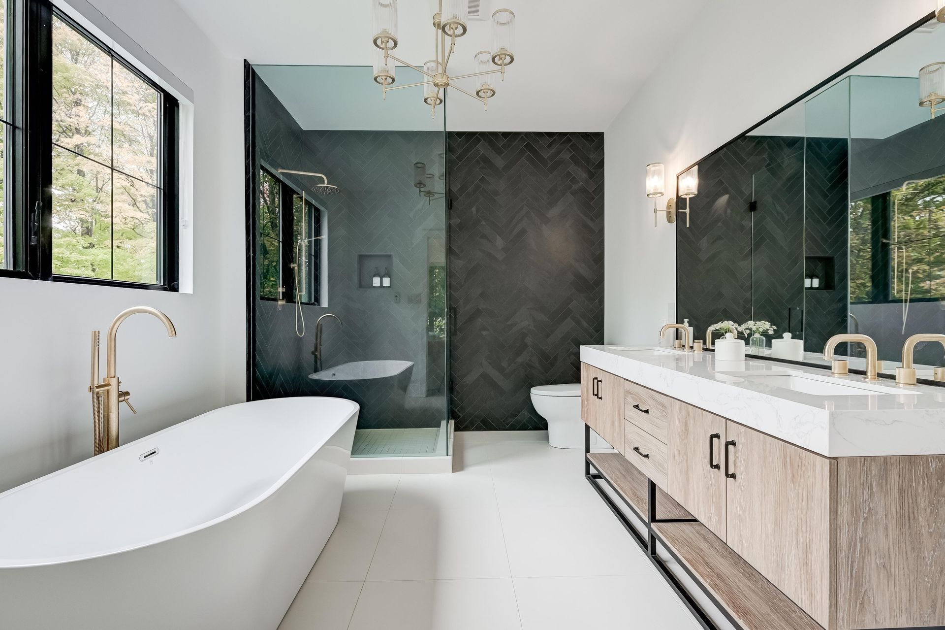 A bathroom with a tub , shower , sink and mirror.