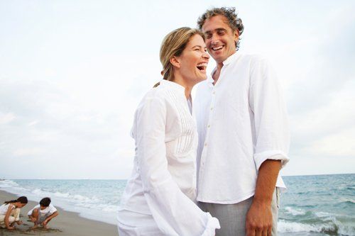 happy couple walking on the beach