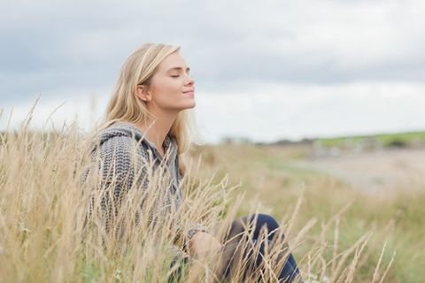 calm woman in wheat grass