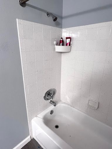 A bathroom with a bathtub and a shower.