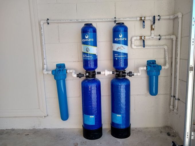Two blue bottles are connected to a white pipe