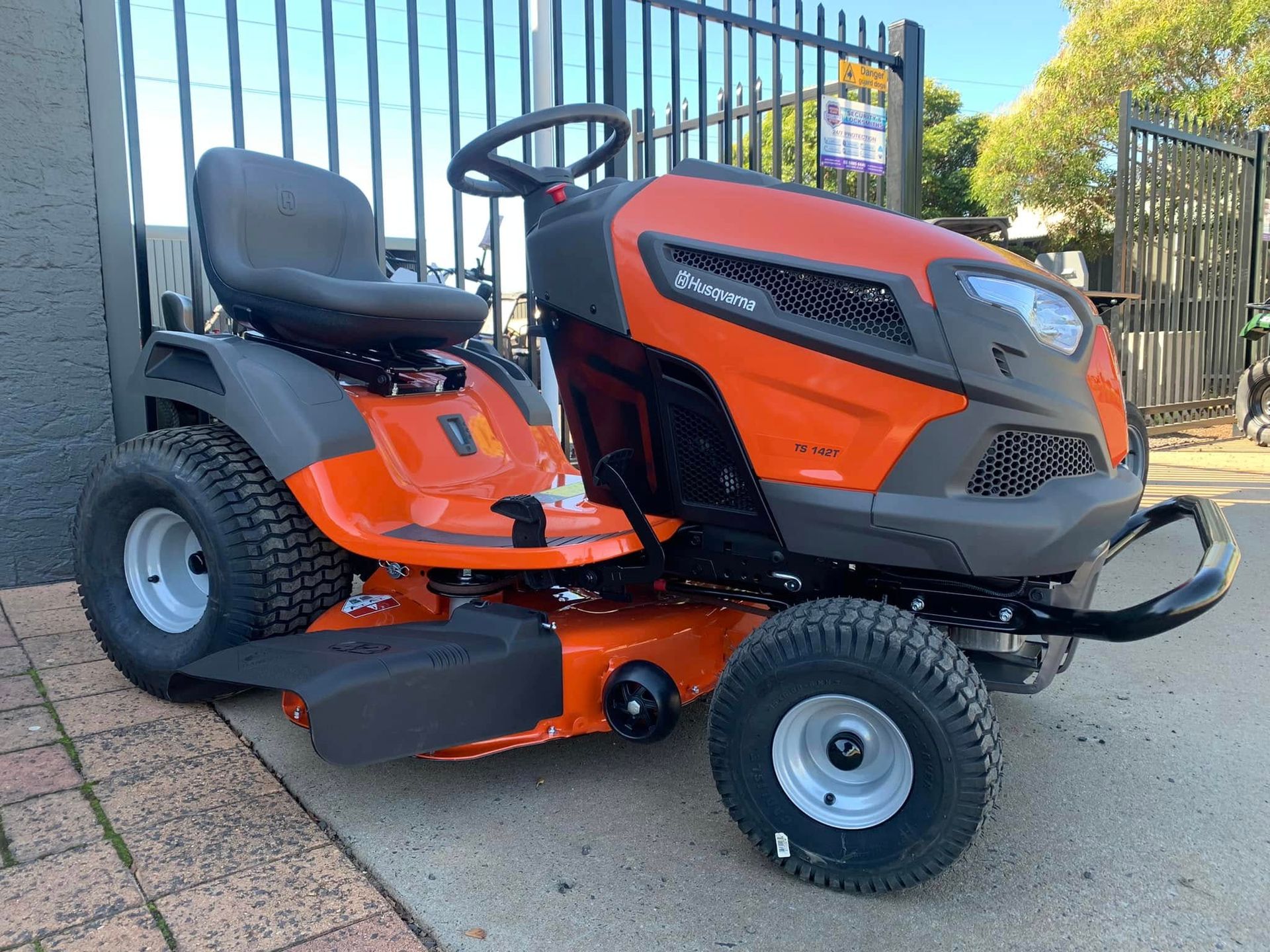 Orange and Gray Husqvarna Riding Lawn Mower Parked — M.M & Mechanical in Dubbo, NSW