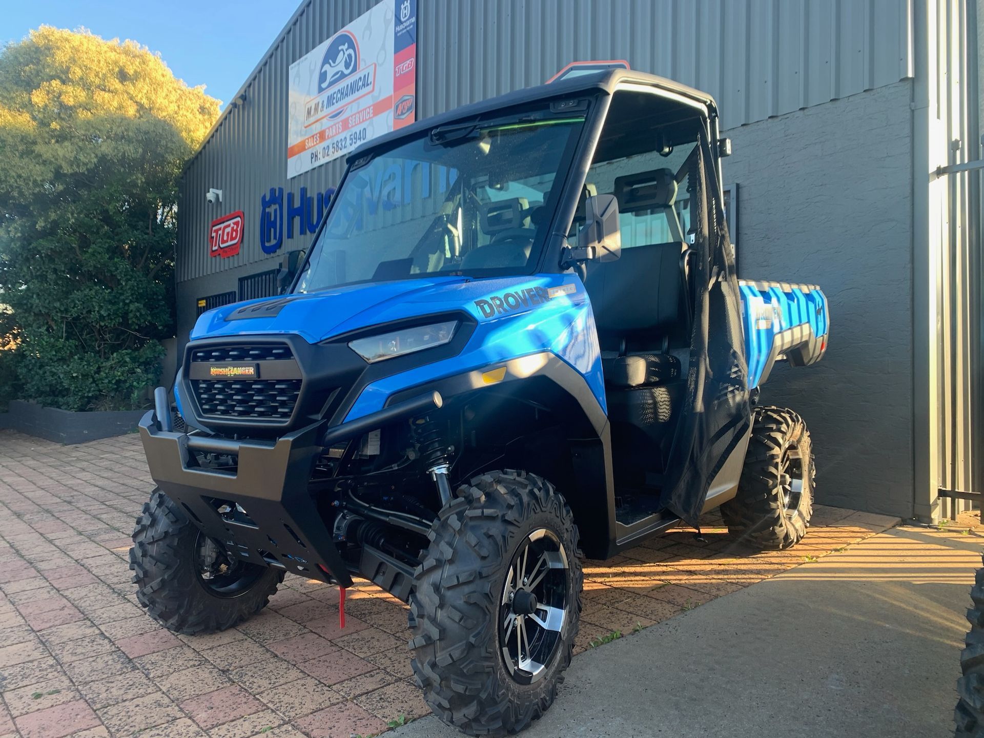 Red and Black ATV With Roll Cage and Oversized Tires in a Garage — M.M & Mechanical in Dubbo, NSW