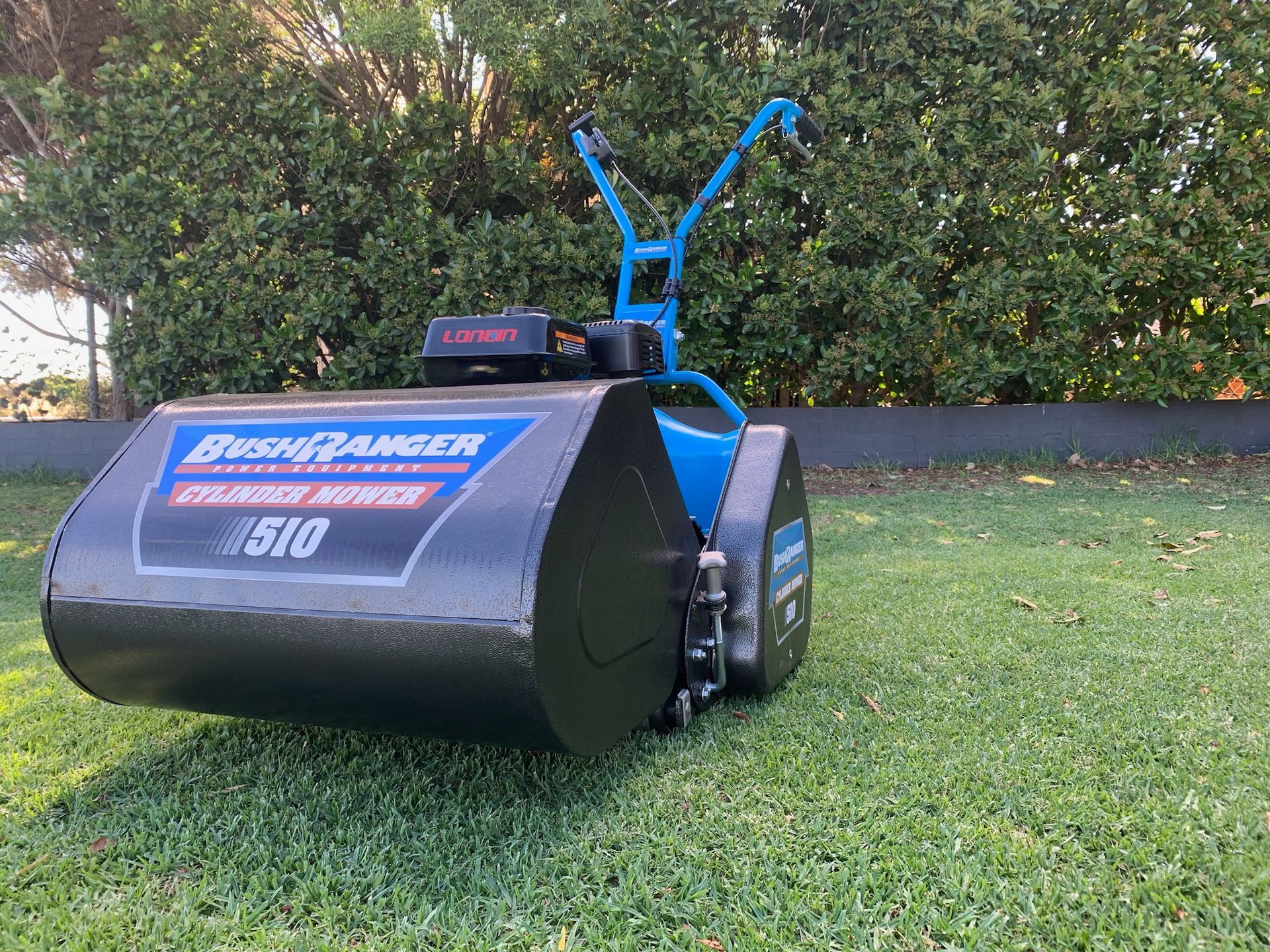 Blue and black Bushranger cylinder mower on green grass — M.M & Mechanical in Dubbo, NSW
