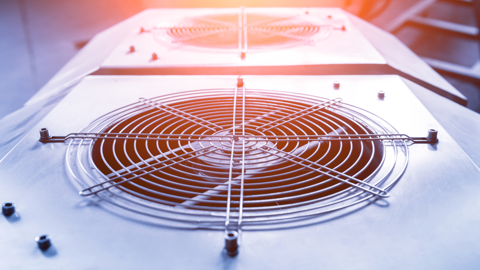 A close up of a fan on top of a building.