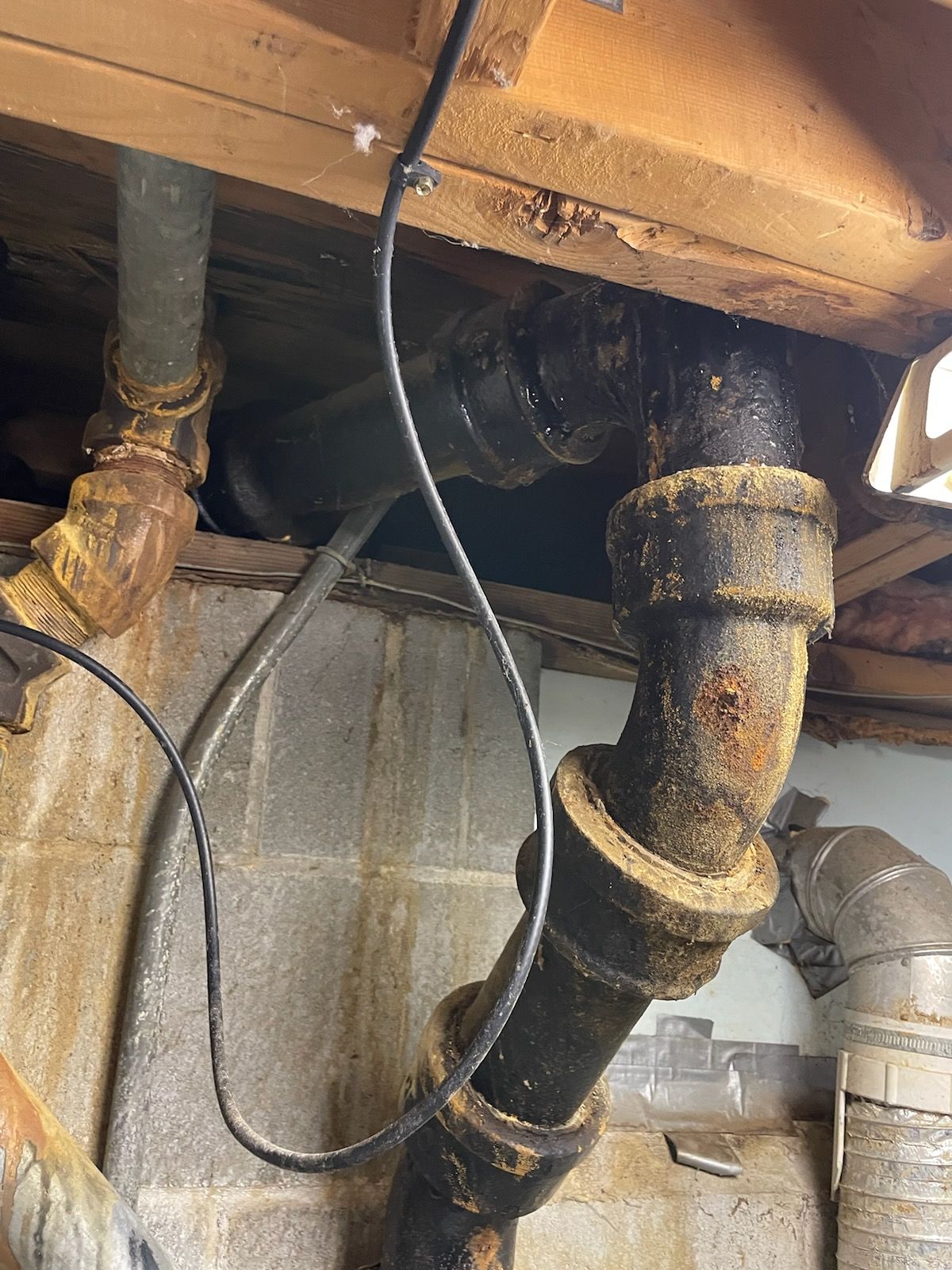 A bunch of pipes are connected to each other in a basement.