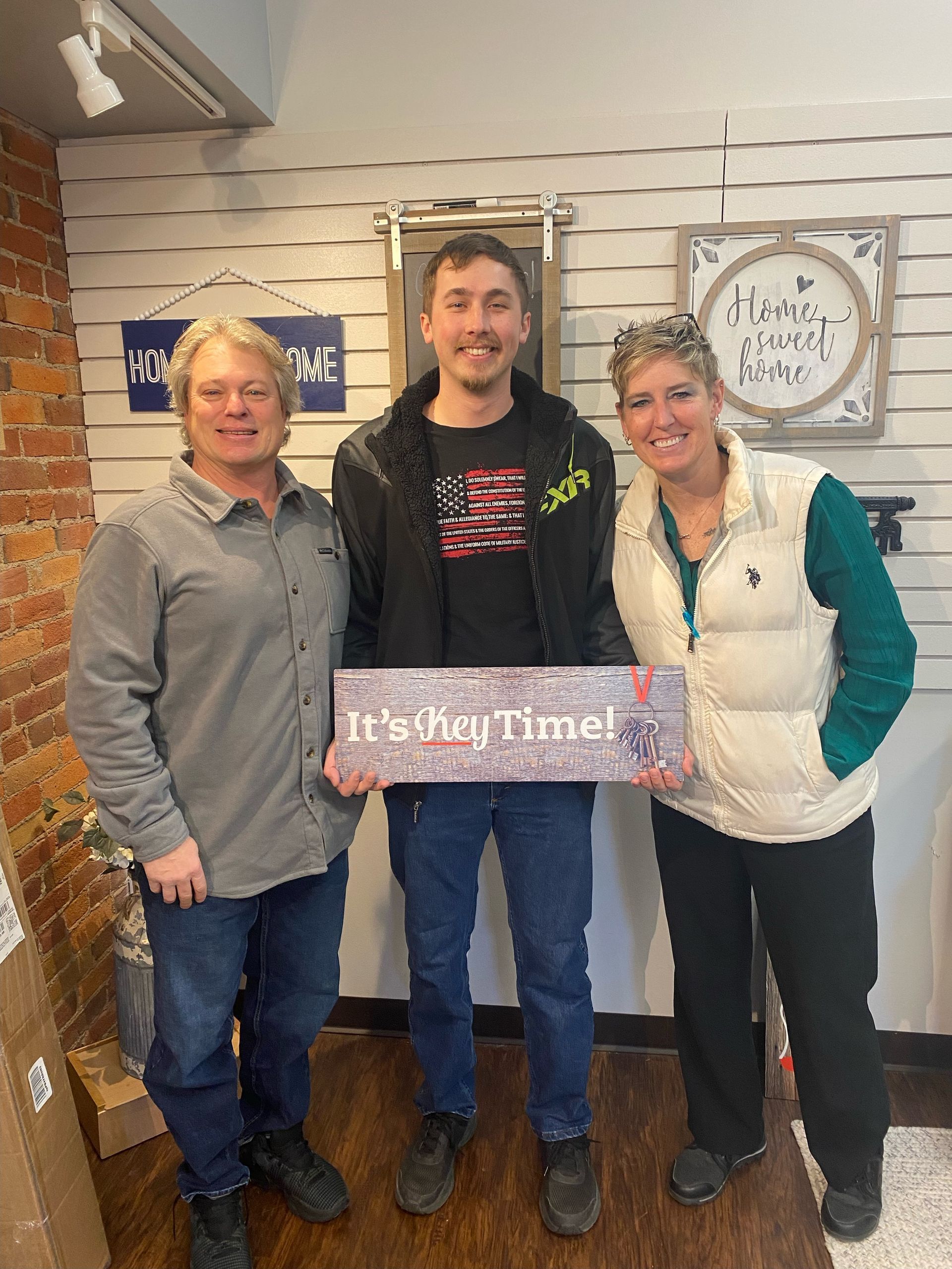 three people are standing next to each other holding a sign that says `` it 's dog time '' .