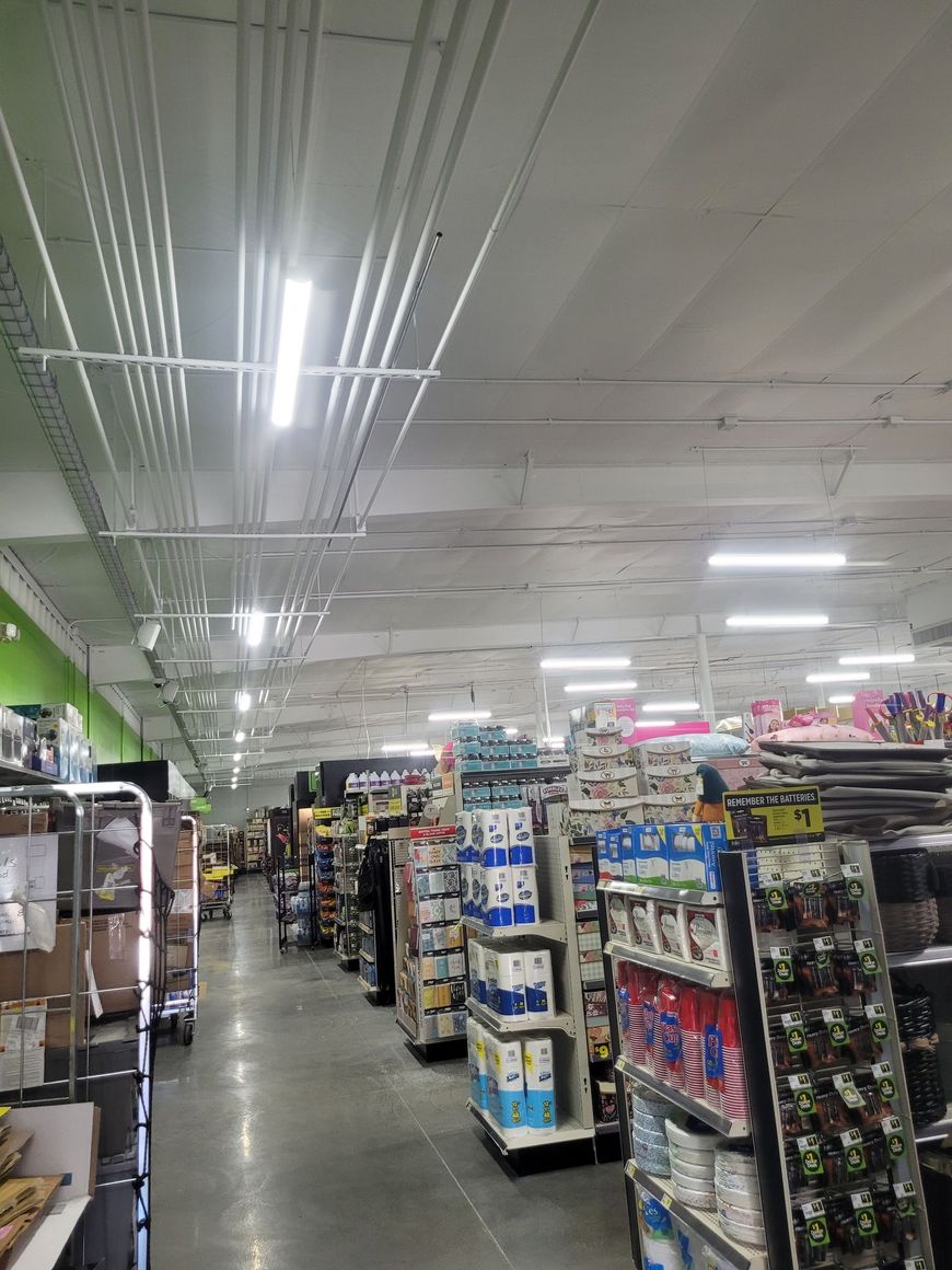 A grocery store aisle filled with lots of toilet paper.