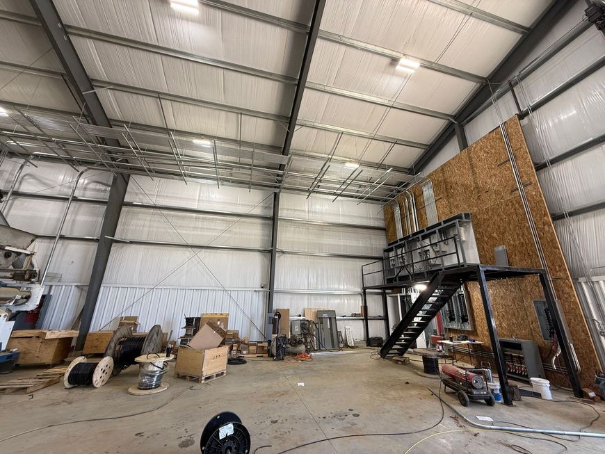 A large warehouse filled with lots of boxes and stairs.