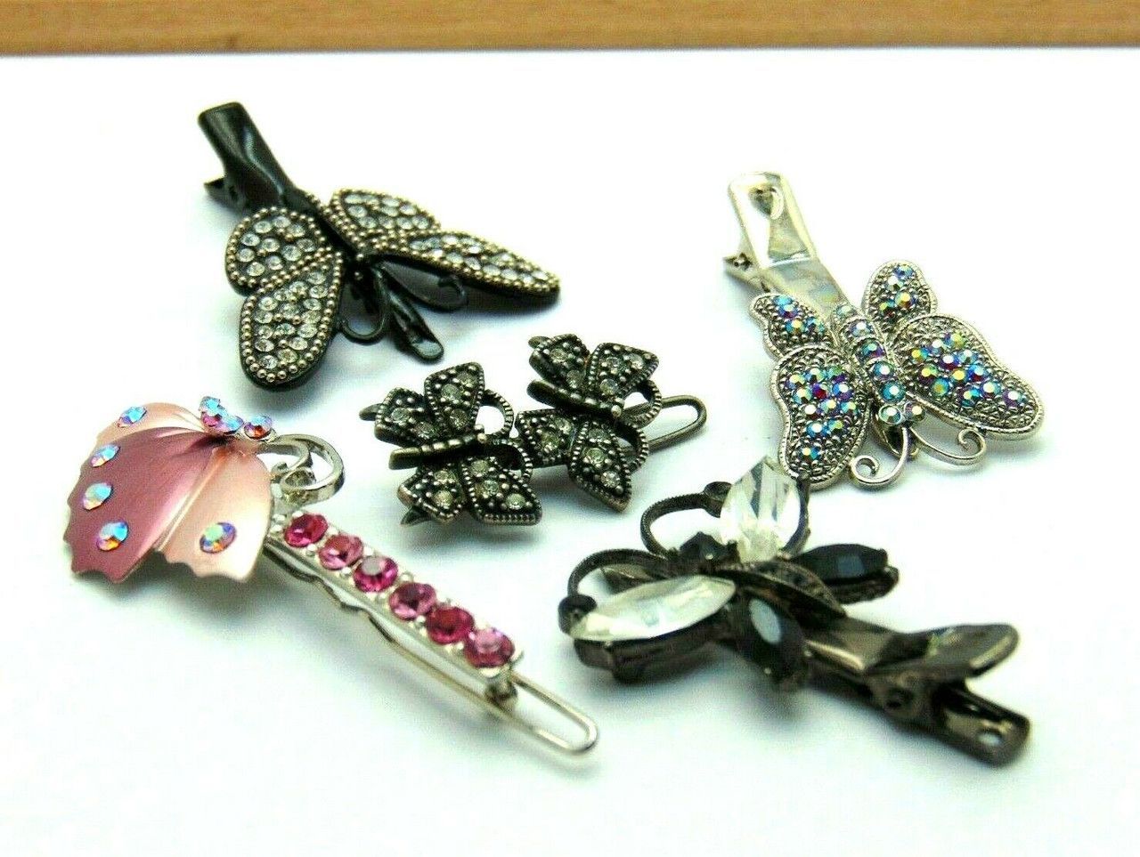 A bunch of hair clips with butterflies on them