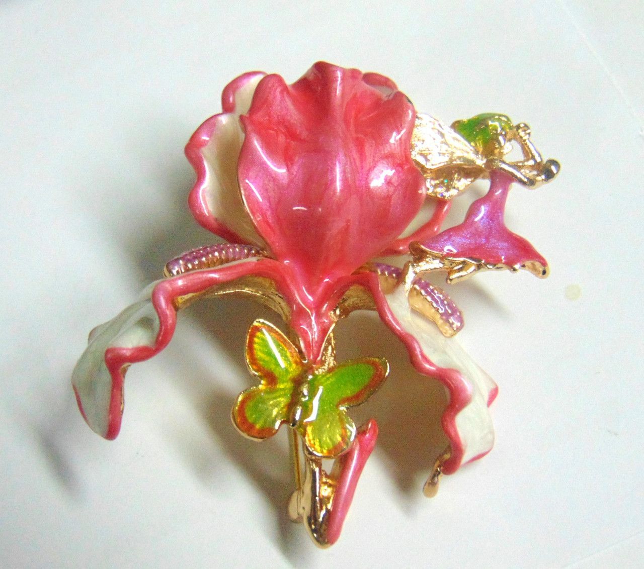 A person is holding a pink flower in front of a field of flowers.