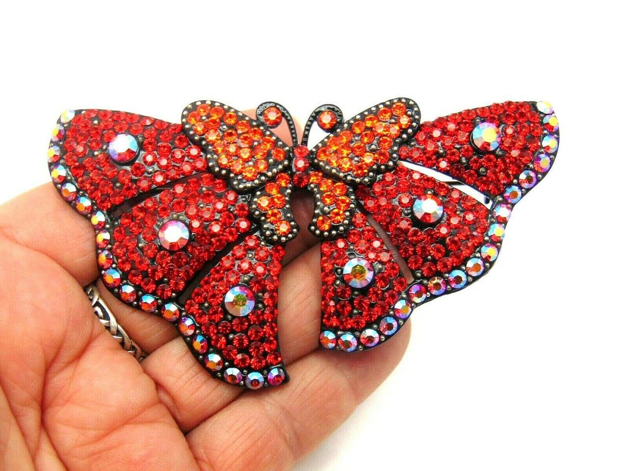 A pair of red butterflies with rhinestones on them