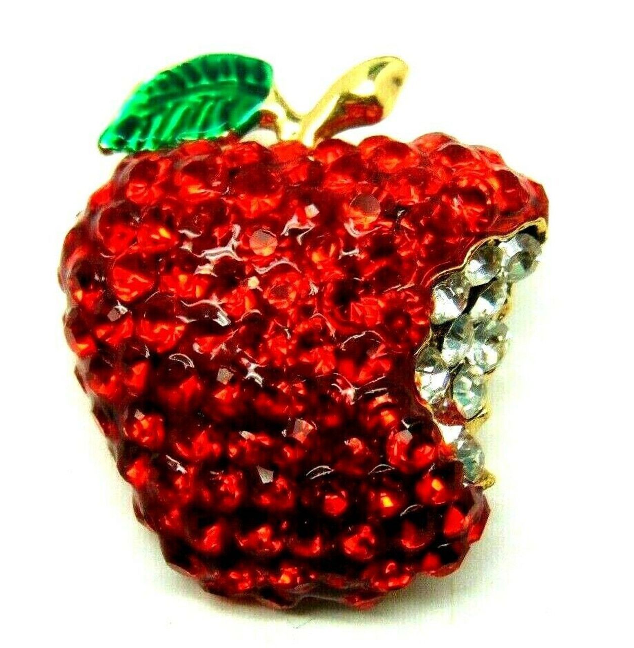 A person is holding a ring in the shape of a strawberry.