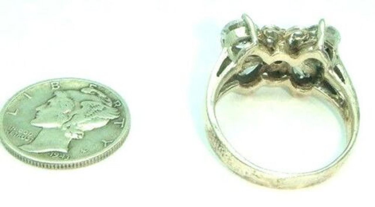 A dime and a ring are next to each other