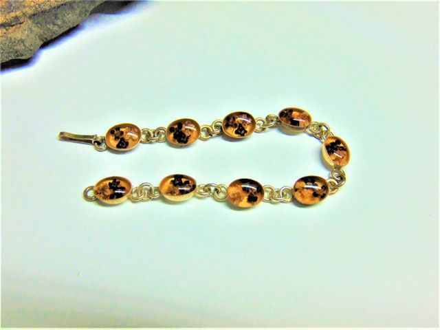 A close up of a bracelet on a rock