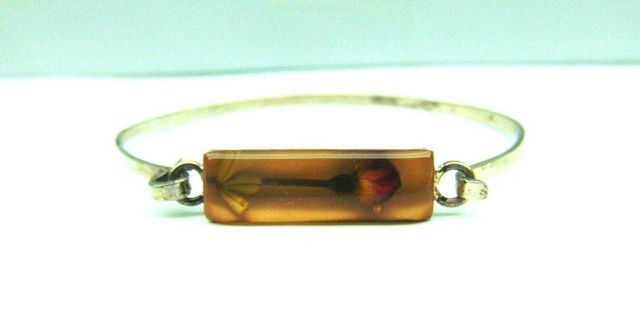 A person is holding a bracelet in their hand