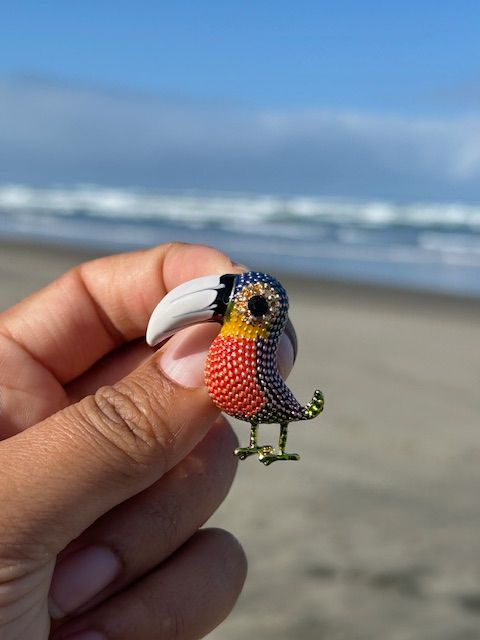 A colorful bird with a large beak is sitting on a rock