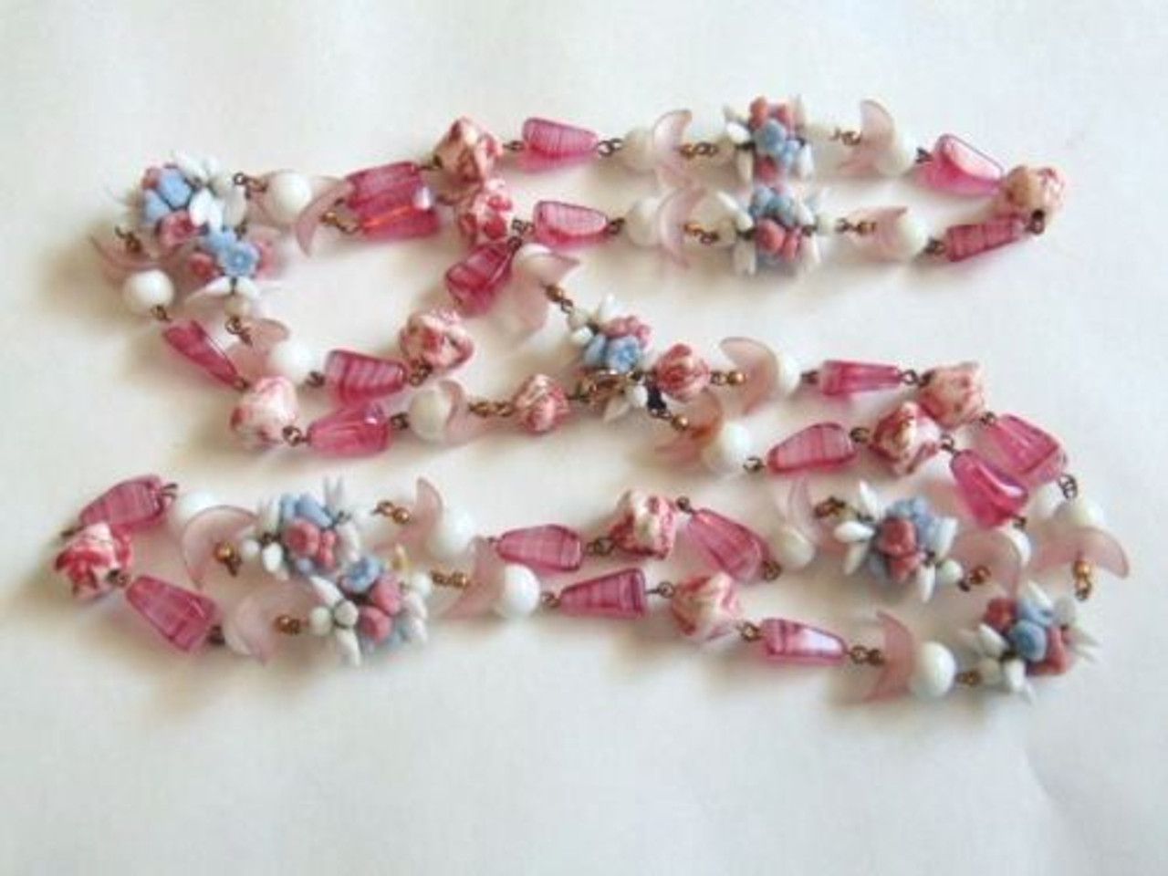 A bunch of pink and white beads with flowers on them