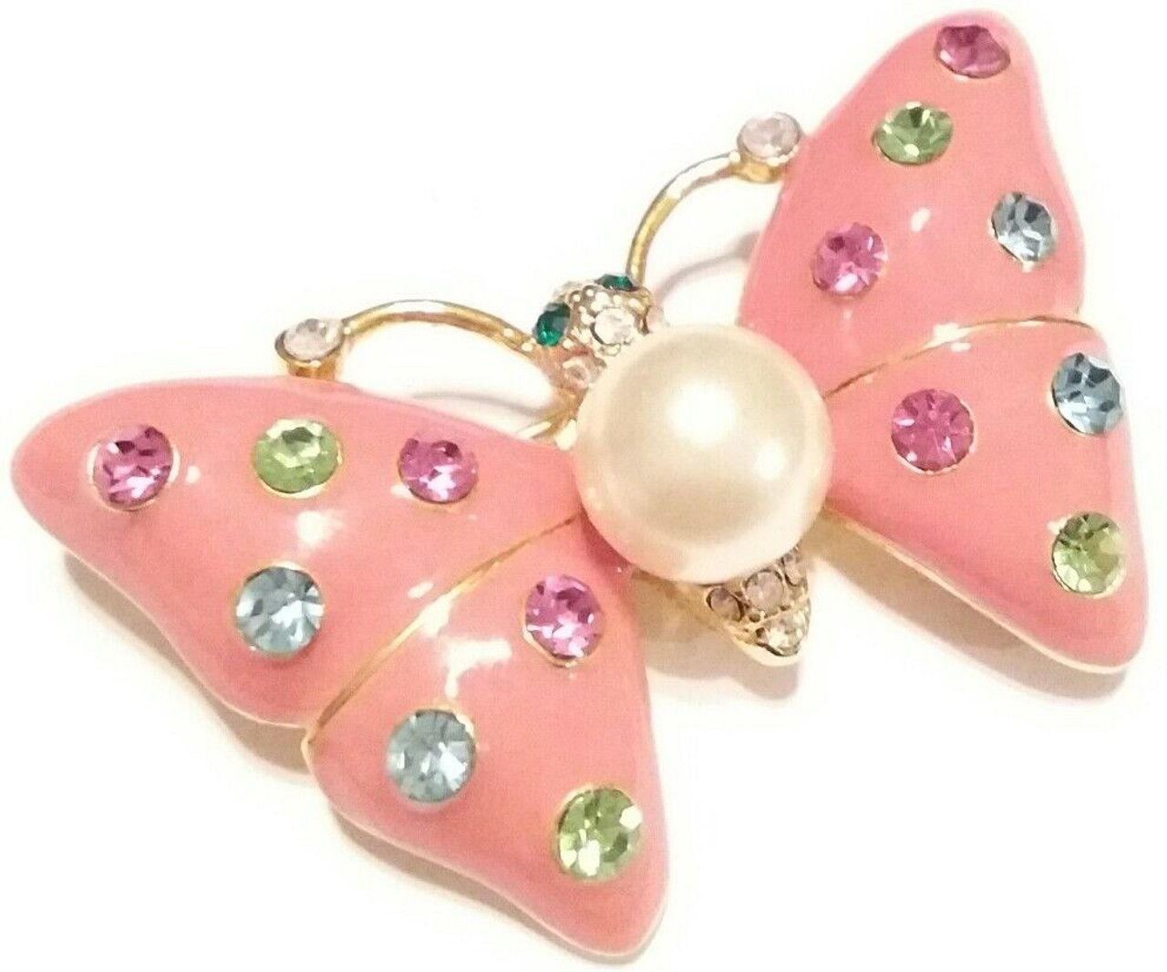 A pink butterfly brooch with a pearl and rhinestones