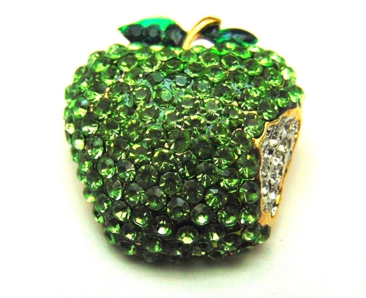 A brooch in the shape of an apple covered in green rhinestones