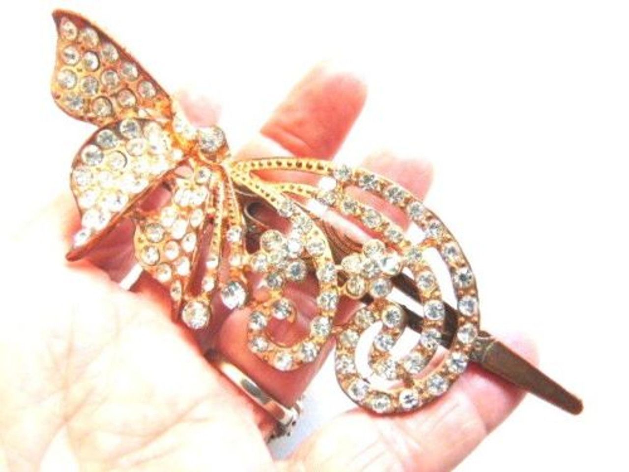 A hair clip with a butterfly design and rhinestones