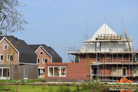 a house under construction with scaffolding on the roof