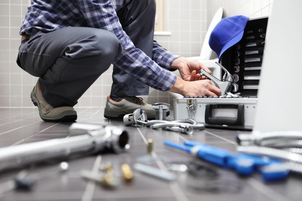 Plumber At Work In Bathroom — Mainline Plumbing & Civil Pty Ltd In Dubbo, NSW