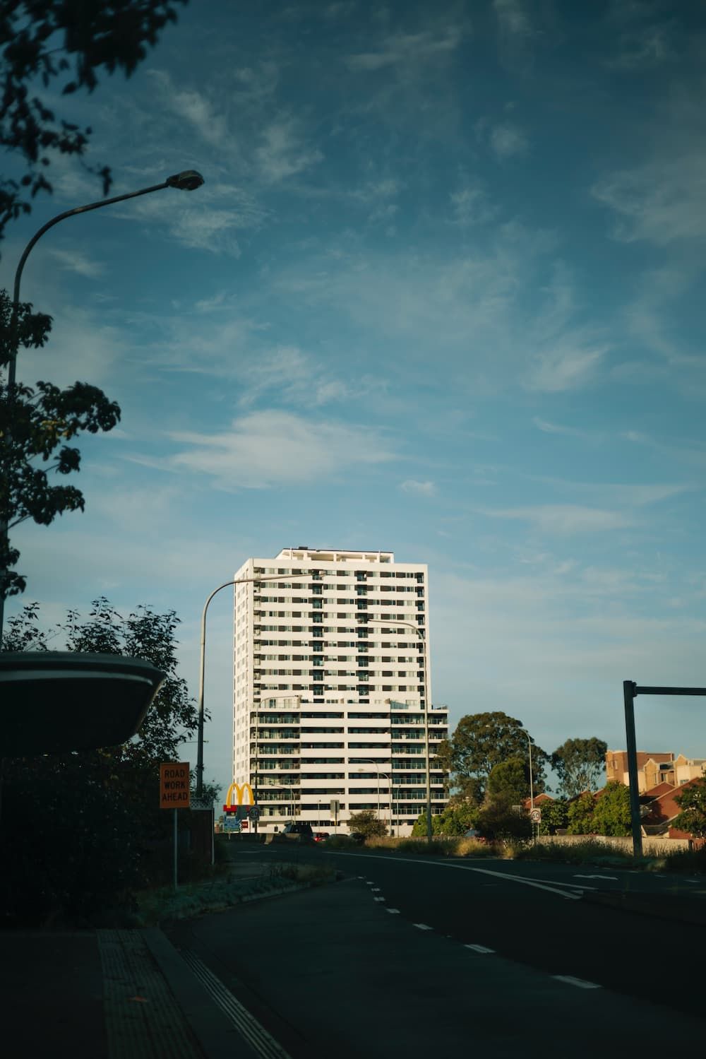 A Tall Building is Sitting on the Side of a Road — Mainline Plumbing & Civil Pty Ltd In Blacktown, NSW