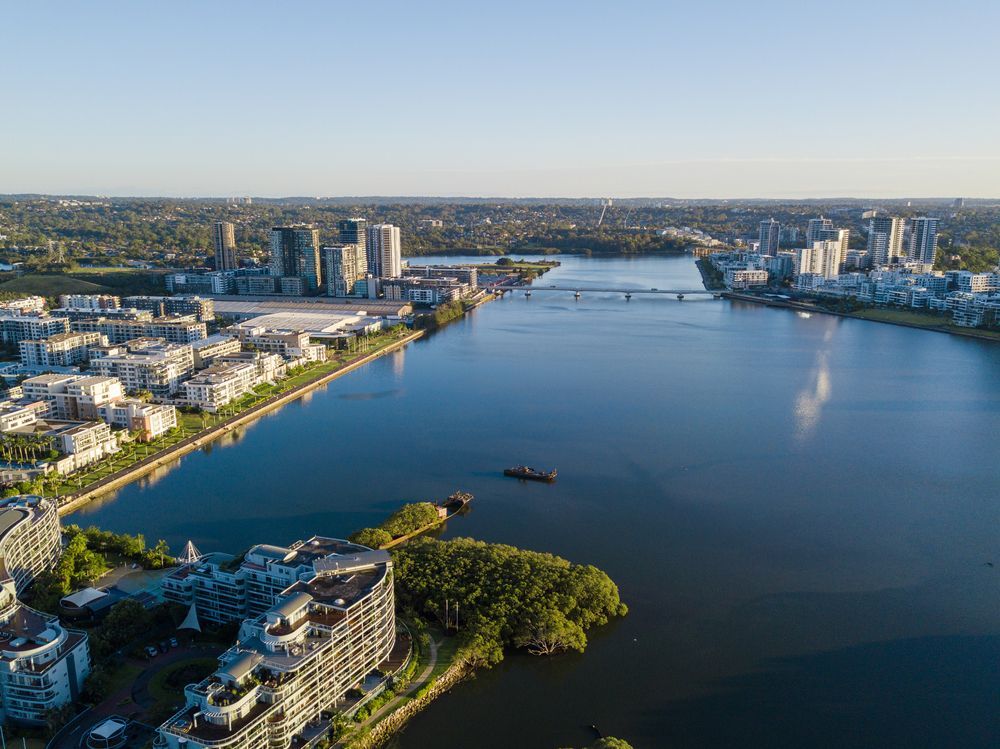 An Aerial View of a Large Body of Water Surrounded by Buildings — Mainline Plumbing & Civil Pty Ltd In Homebush, NSW
