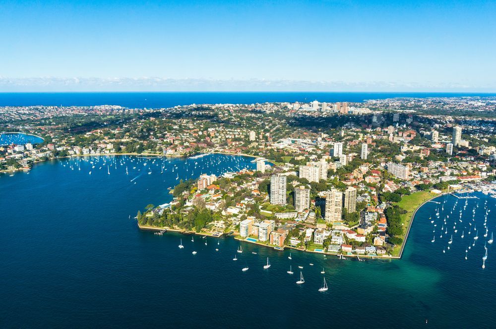 An Aerial View of a City Surrounded by Water and Boats — Mainline Plumbing & Civil Pty Ltd In Double Bay, NSW