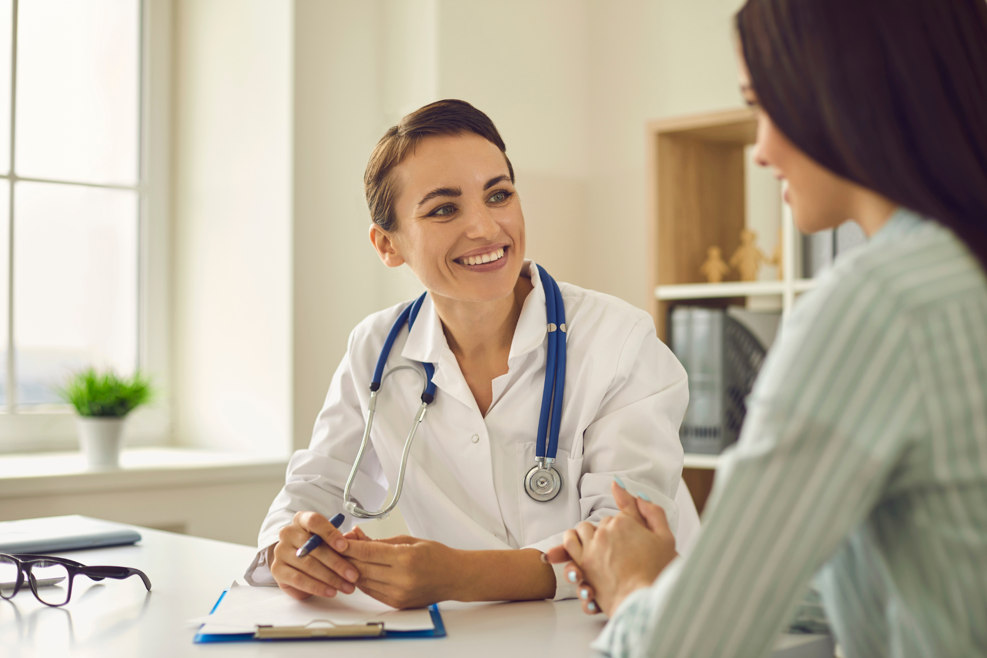 medical provider smiling, looking at a patient