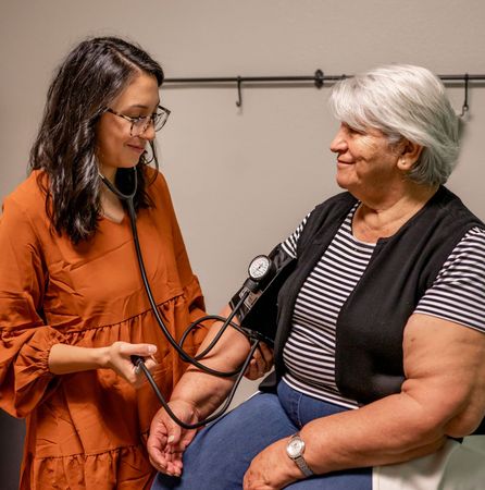 A nurse is taking a patient's blood pressure.