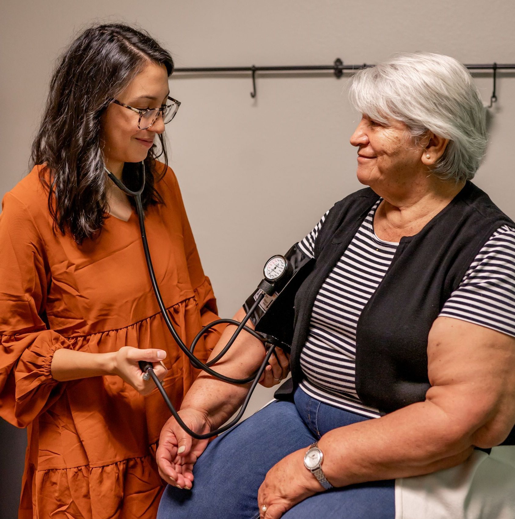 A nurse is taking a patient's blood pressure