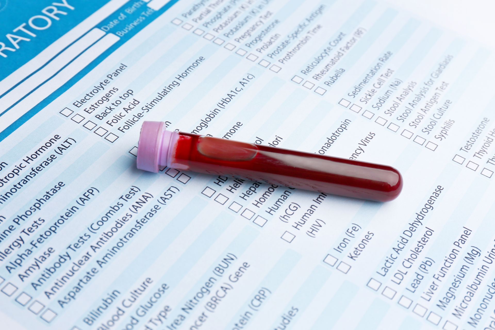 A test tube with a blood sample placed on a laboratory testing form