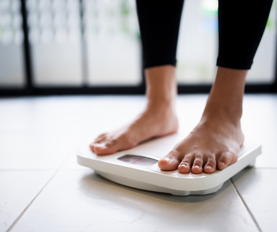 woman weighing herself on a weighing scale