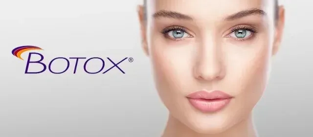 A close up of a woman 's face with botox in the background.