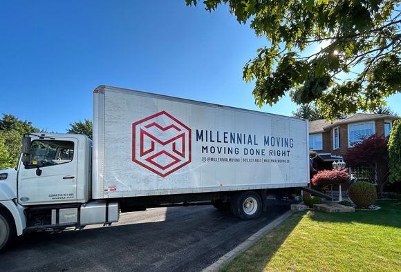 a millennial moving truck is parked in front of a house